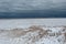 Frozen sand and ice creating a massive block on Lake Michigan on gloomy overcast day