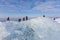 Frozen sea near Dutch coast and people exploring drifting ice