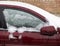 Frozen side window of burgundy red car