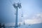 Frozen ski lift covered frost on gloomy day snowy mountains