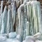 Frozen small mountain waterfall close up