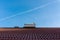 Frozen solar water heater boiler on rooftop, passing aeroplane