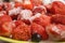 Frozen strawberries and pieces of ice on a dish