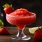 Frozen strawberry margarita garnished with a salt rim on dark background. Margarita with crushed ice. Frozen summer red cocktail