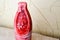 Frozen, tasty, red grated strawberry. Frozen bright berries in the form of a bottle in a cut