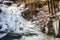 Frozen tiered waterfall covered in beautiful ice formations