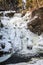 Frozen tiered waterfall covered in beautiful ice formations, portrait