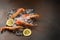 Frozen tiger shrimp on ice on a dark stone table