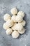 Frozen uncooked baozi dumplings stuffed with meat. Gray background. Top view