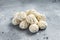 Frozen uncooked baozi dumplings stuffed with meat. Gray background. Top view