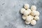 Frozen uncooked baozi dumplings stuffed with meat. Gray background. Top view. Copy space