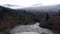 Frozen Valldola river on Trollstigen route in snow in Norway