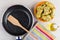 Frozen vegetable nuggets, frying pan, spatula, napkin, bottle of