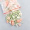 Frozen vegetables in the plastic bag and on a table, top view, square format