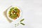 Frozen vegetables on white plate: corn, string beans, pepper, green peas, beans and carrot. Top view with