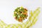 Frozen vegetables on white plate: corn, string beans, pepper, green peas and carrot. Top view with copy space