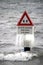 Frozen water on a arning sign for dangerous swimming water caused by holes on the bottom of lake named Zevenhuizerplas