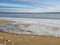 Frozen water at the beginning of winter on the freezing Volga on a Sunny day