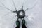 Frozen water in lake with crack formation on the ice, beautiful shape and pattern and a pair of legs with rubber boots.