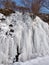 Frozen water side of mountain waterfall abstract