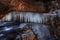 Frozen waterfall in mountain gorge