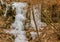 Frozen waterfall on side of mountain