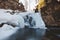 Frozen waterfall under snow cover in Wisla Czarne - Rodla Cascades in the Polish Beskydy Mountains, Poland. Wild nature and its