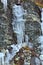 Frozen waterfalls on the lichen covered rocks