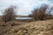 Frozen winter pond in a dry grassy landscape