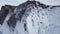 Frozen after winter storms, water splashes on the cliffs of the shore. Lake Baikal in early spring. Siberia. Russia