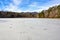 Frozen wintry landscape of cracked ice full of holes at Lake Powhatan in North Carolina