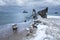 Frozen wooden breakwaters line to the world war II torpedo platform at Baltic Sea