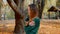 Frozen young attractive brunette woman is walking in the park on a background of yellowed trees in autumn