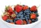 Fruit assorted platter with lot ripe appetizing strawberry and honeysuckle isolated ob white background studio shot close up