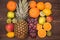 Fruit background with orange, kiwi, grape, apples and lemon on the wooden table