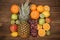 Fruit background with orange, kiwi, grape, apples and lemon on the wooden table