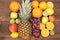 Fruit background with orange, kiwi, grape, apples and lemon on the wooden table