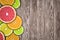 Fruit background with slices of orange, grapefruit, lemon and lime on wooden desk.