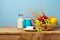 Fruit basket and dairy products on wooden table. Jewish holiday Shavuot background