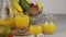 Fruit basket and glass of juice. Fresh Mango juice, orange juice. Fruit basket on the table. Fresh fruits and juic