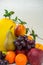 Fruit basket on white background with apple, pear melon grapes orange banana