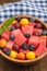 Fruit and berry salad of watermelon, blueberries, plums, currants, gooseberry, cherry plum. Wooden background. Top view