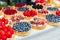 Fruit and berry tarts dessert tray assorted outdoors