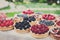 Fruit and berry tarts dessert tray assorted outdoors