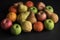 Fruit on black background, apple, pear, orange, mandarin