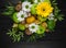 Fruit bouquet with apples, yellow flowers, kiwi fruit and avocado.