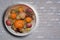 Fruit bowl on grey washed brick