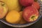 Fruit in a bowl: melon, apples, orange, pomegranate.