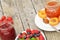 Fruit bowl, strawberry, apricot jam on a decorative plate