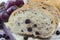 Fruit bread with aronia sliced on a wooden plate with dried aron